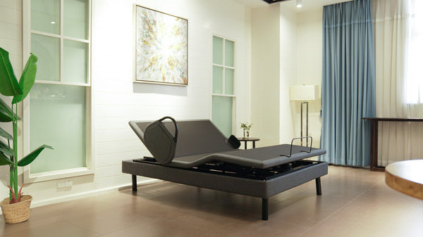 Ergomotion Ascend high-low adjustable bed with the head raised, in a bedroom - Bedplanet