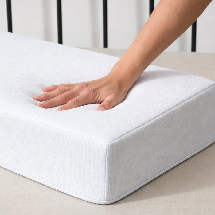 Hand pressing into the Side Cube Riser Deluxe memory foam surface