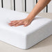 Hand pressing into the Side Cube Riser Deluxe memory foam surface