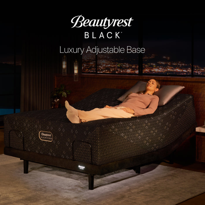 Beautyrest Black Luxury Adjustable Base with a Beautyrest Black mattress raised at the head in a dark bedroom