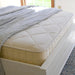 Naturepedic Serenade Organic Hybrid Mattress on bed frame