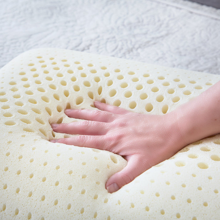 Hand pressing into the springy Talalay latex of the Malouf Zoned pillow