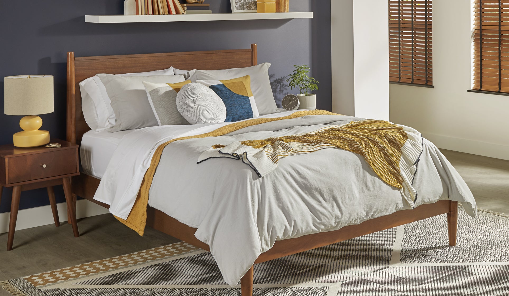 Mom and son eating breakfast in bed on a Sealy® bed