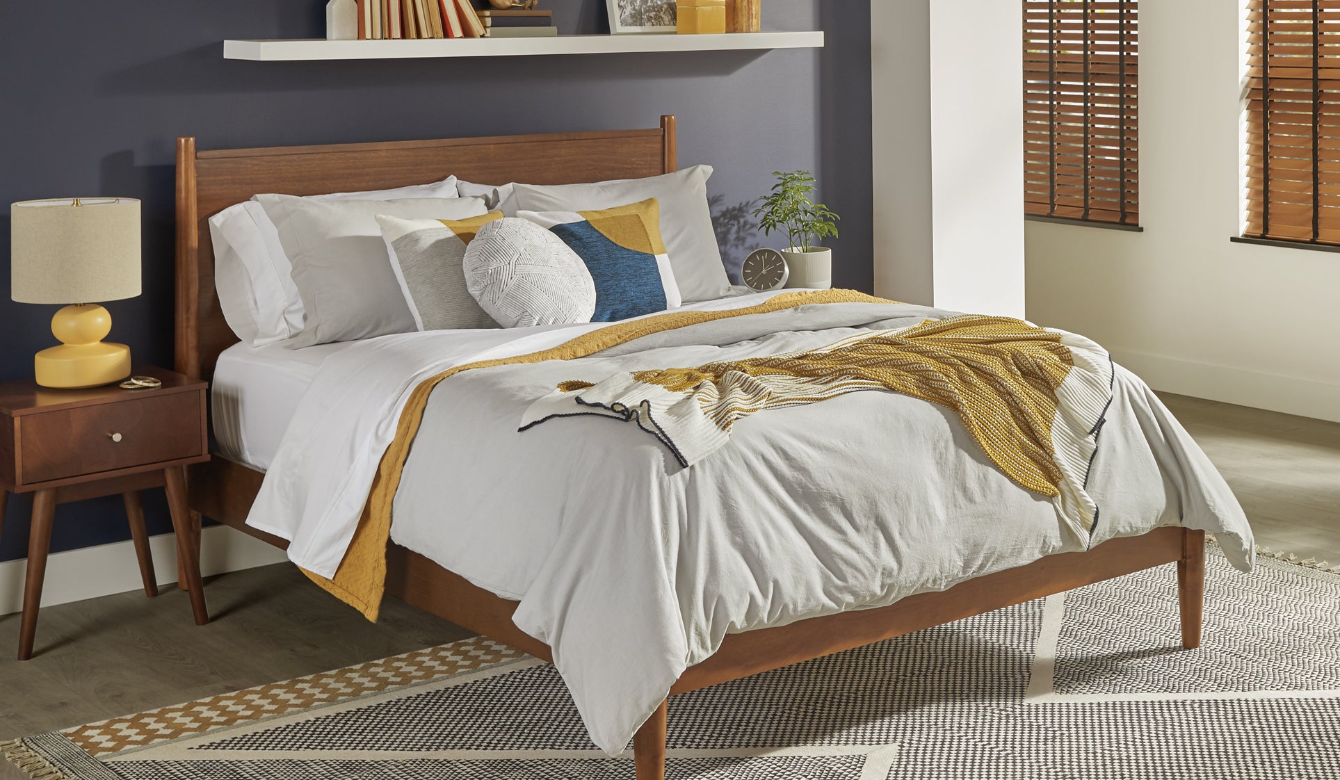 Mom and son eating breakfast in bed on a Sealy&reg; bed